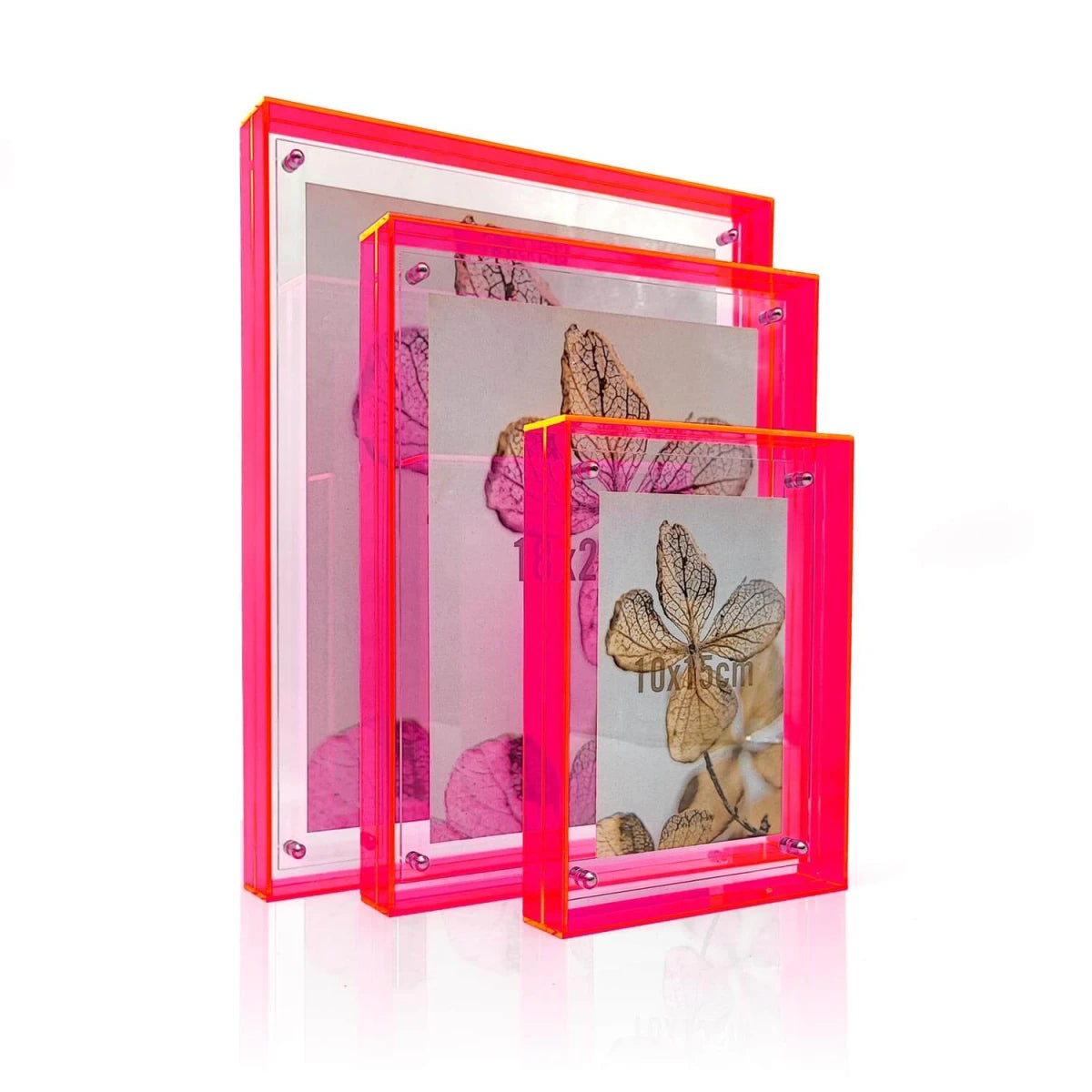 drei Bilderrahmen hintereinander stehend in neonpink