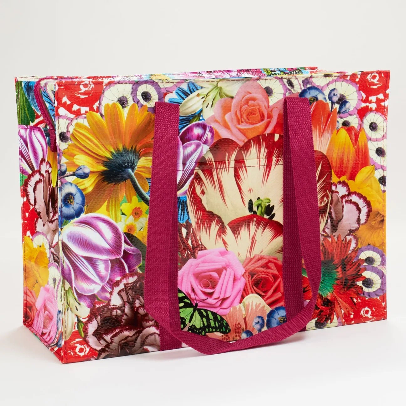 Bunte Einkaufstasche mit Blumenmuster und zwei langen, pinken Tragegriffen