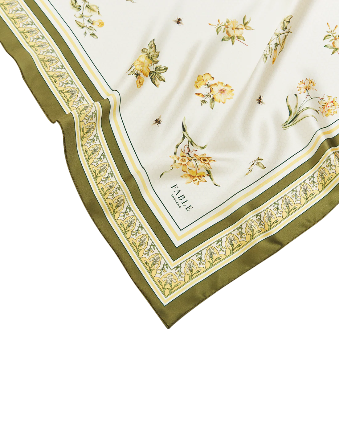 Nahaufnahme der Tuchecke mit dem 'Fable England' Schriftzug. Deutlich erkennbar sind die feine Textur des Stoffes und die detailreichen Zeichnungen der Bienen und Blüten.