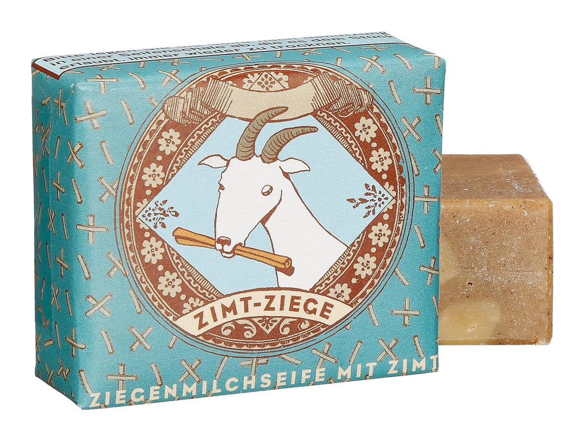 Verpackte Zimt-Ziege Ziegenmilchseife von 1000 und 1 Seife in blauem Papier mit Ziegen-Illustration und Seifenstück.
