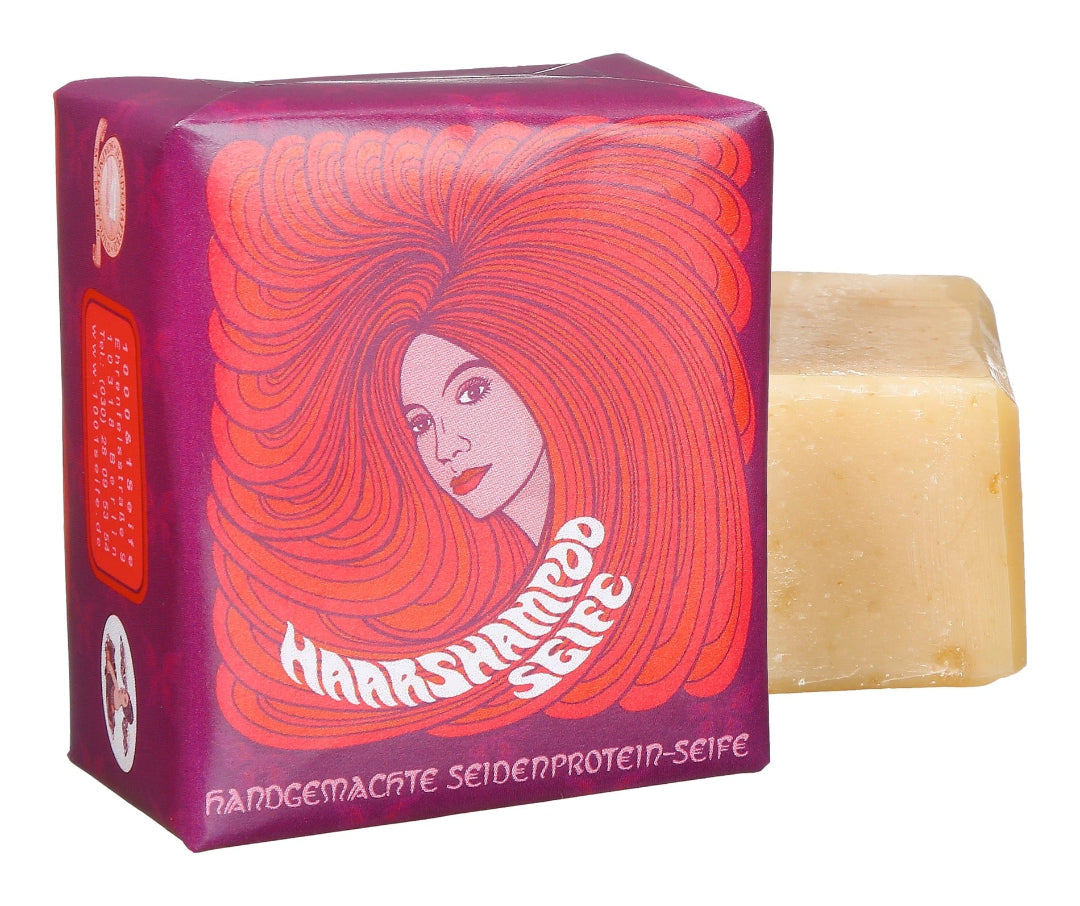 • 
Haarshampoo Seife von 1000 und 1 Seife in rot-oranger Verpackung mit Illustration einer Frau mit langen Haaren
