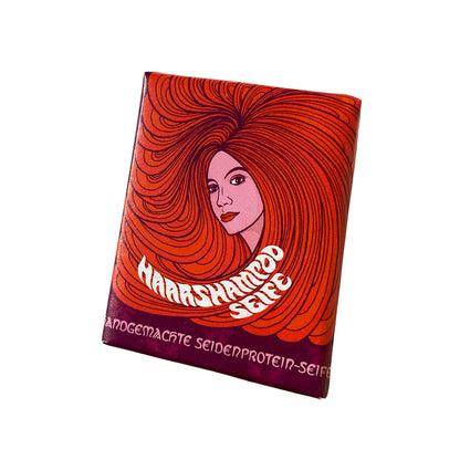 • 
Haarshampoo Seife von 1000 und 1 Seife in rot-oranger Verpackung mit Illustration einer Frau mit langen Haaren

