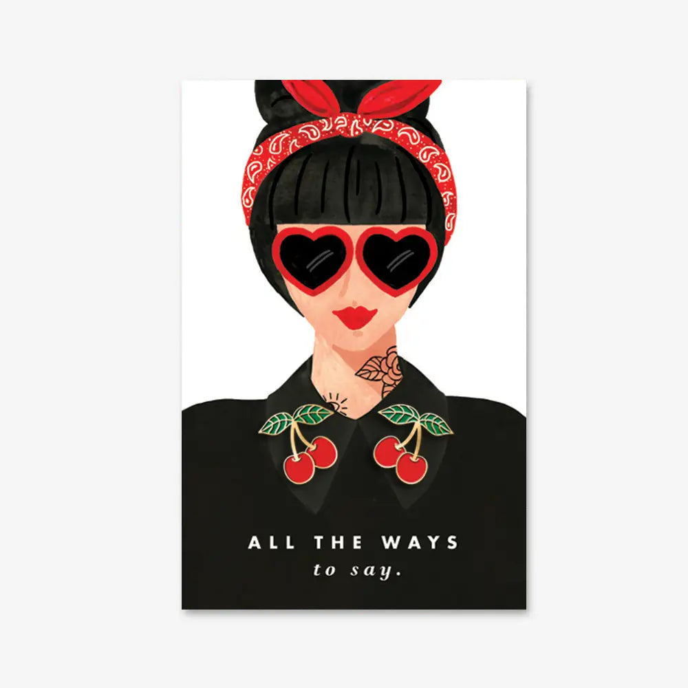 Illustration einer Frau mit schwarzem Haar, rotem Bandana, herzförmiger Sonnenbrille und Kirschen auf dem schwarzen Hemdkragen, Text 'ALL THE WAYS to say.‘