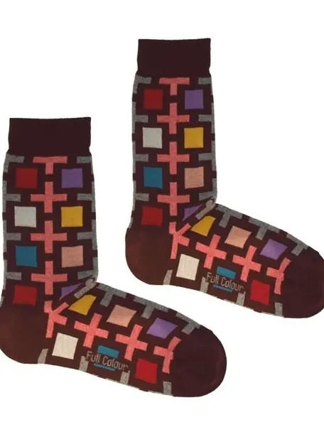 Bunte Socken mit geometrischem Muster aus Quadraten und Kreuzen in Rot, Blau, Gelb und Lila auf braunem Grund