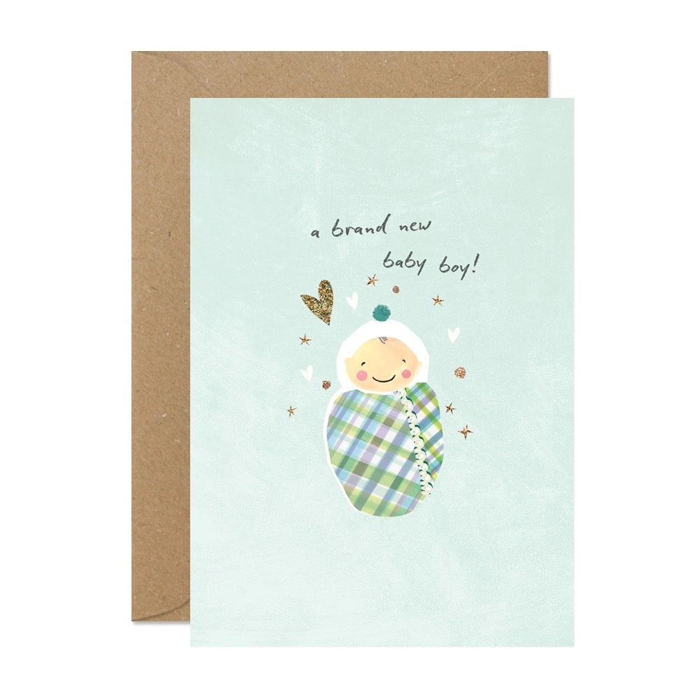 Grußkarte zur Geburt eines Jungen in Hellblau mit Baby in karierter Decke.