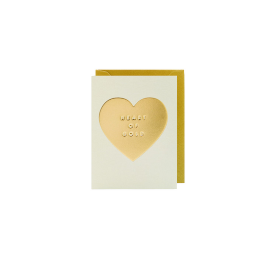 Karte mit goldenem Herz und dem Schriftzug 'HEART OF GOLD' auf cremefarbenem Hintergrund, goldener Umschlag 