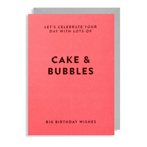 Neonorangefarbene Geburtstagskarte mit dunkellila Text 'LET'S CELEBRATE YOUR DAY WITH LOTS OF CAKE & BUBBLES' und 'BIG BIRTHDAY WISHES', grauer Umschlag dahinter.