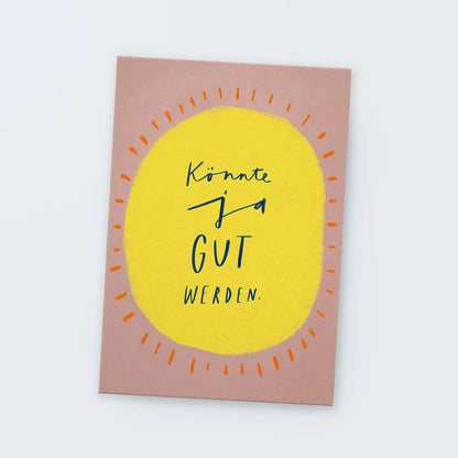 Postkarte mit gelbem Oval und dem Text 'Könnte ja GUT werden.' auf rosa Hintergrund
