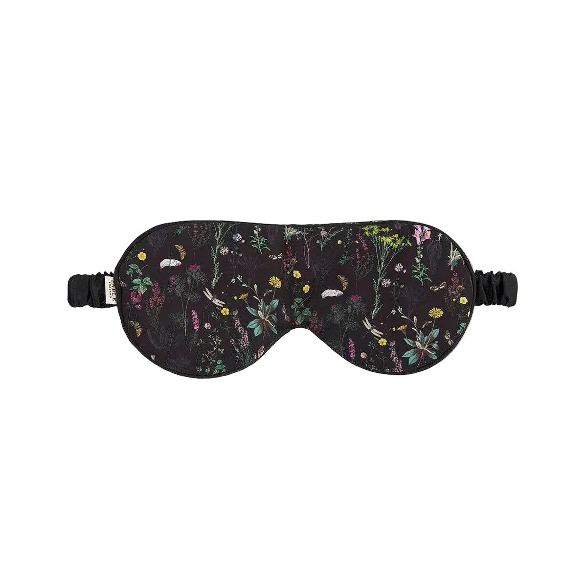 Vorderansicht einer schwarzen botanischen Wildblumen-Schlafmaske mit elastischem Kopfband, zentriert auf grauem Hintergrund.