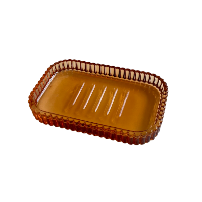 Rechteckige, durchsichtige Seifenschale in braun mit geriffeltem Rand und Rillen in der Mitte.