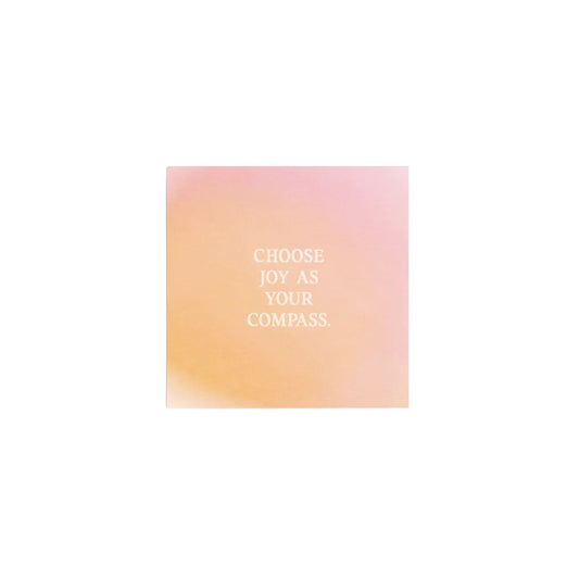Minimalistische quadratische Minikarte von Anna Cosma mit dem Text „CHOOSE JOY AS YOUR COMPASS.“ auf einem sanft verlaufenden Hintergrund in Apricot, Orange und Rosa.