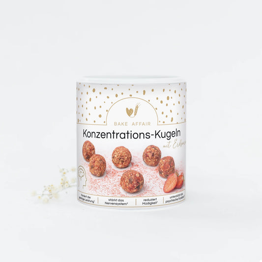 Runde Konzentrations-Kugeln in einer weißen Dose mit goldenen Punkten und der Aufschrift 'Bake Affair Konzentrations-Kugeln mit Erdbeere'.