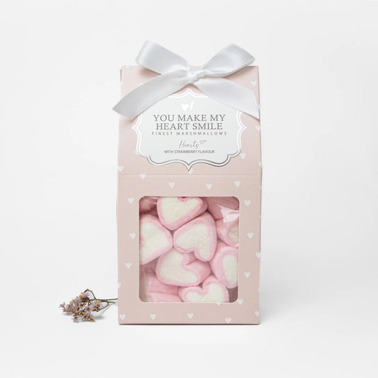Rosa Geschenkbox mit Marshmallow-Herzen, weißer Schleife und Aufschrift „You make my heart smile“