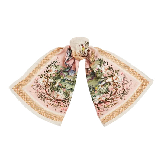 Ein rosafarbener Fable England Schal mit Vogel- und Blumenmotiven, mittig geknotet, zeigt die symmetrische Anordnung der Illustrationen.