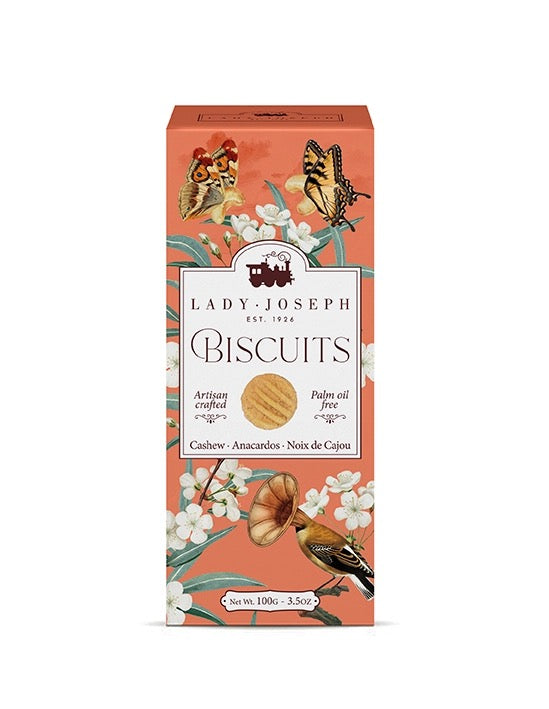 Verpackung für Lady Joseph Cashew-Biscuits mit Blumen, Schmetterlingen und einem Vogel auf orangefarbenem Hintergrund.