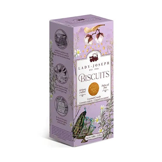 Hellviolette Verpackung mit floralen Illustrationen, einem Pfau und der Aufschrift 'Lady Joseph Biscuits Caramel Crunch'.