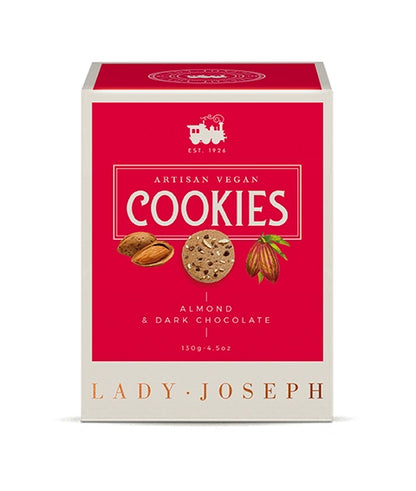 Frontale Produktansicht der Cookie-Verpackung der Marke „Lady Joseph“. Im Zentrum des magentaroten Feldes steht der weiße Schriftzug „ARTISAN VEGAN COOKIES“ sowie darunter „ALMOND & DARK CHOCOLATE 130g“. In der Mitte sind kleine Grafiken einer geöffneten Mandel, eines Kekses und einer Kakaobohne abgebildet. Am unteren cremefarbenen Rand steht der Markenname „LADY JOSEPH“.