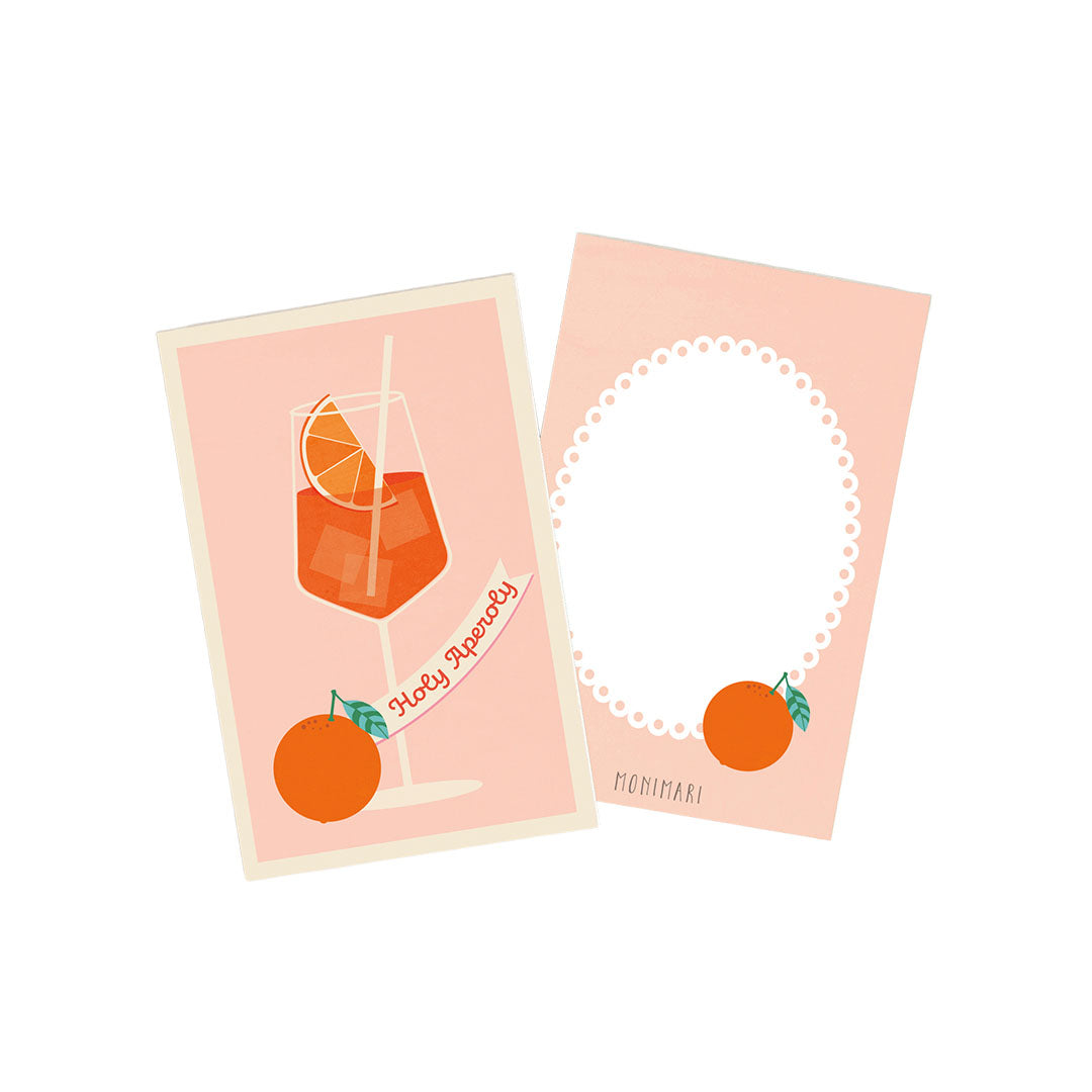 Minikarte von Monimari in zartem Rosa. Vorderseite: Ein Glas mit Aperitif-Cocktail, Eiswürfeln und Orangenscheibe, davor eine ganze Orange und ein Banner mit der Aufschrift „Holy Aperoly“. Rückseite: Rosafarbener Hintergrund mit weißem, geperltem Oval-Rahmen und einer kleinen Orange mit Blatt unten rechts.