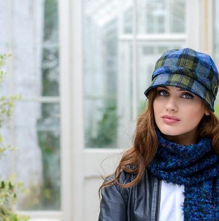 Eine Frau mit blau grünfarbenem, kariertem Flapper Hut.