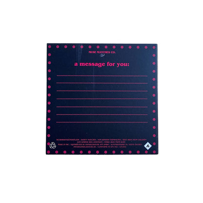 Dunkle, pink gepunktete Rückseite der Fucking Happy Streichholzschachtel mit Linien für persönliche Nachrichten und der Aufschrift a message for you.