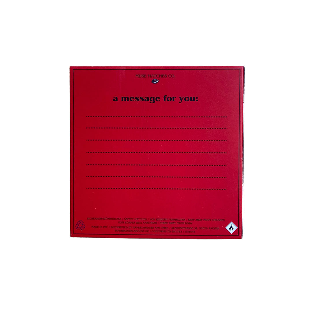 Rote Rückseite einer Muse Matches Co. Streichholzbox mit der Aufschrift a message for you und Linien für eine persönliche Nachricht.