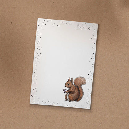 Notizblock mit handgezeichneter Illustration von Eichhörnchen Fritz mit einer Kaffeetasse.