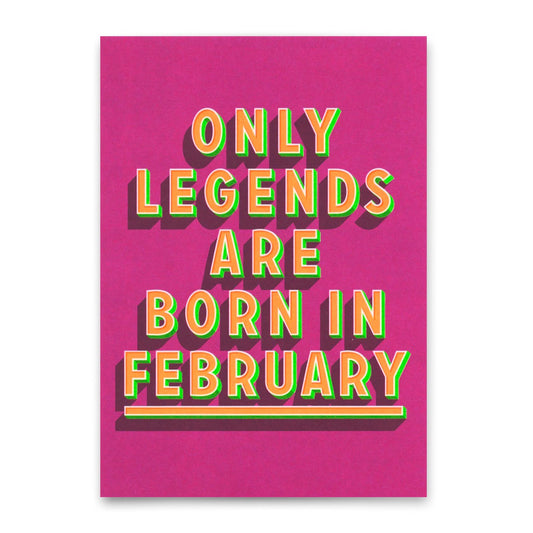 Diese Postkarte verfügt über eine lebendige Typografie im 3D-Stil auf einem hellen Magenta-Hintergrund. Der Text lautet "ONLY LEGENDS ARE BORN IN FEBRUARY" in fetten, dimensionalen Buchstaben mit einem bunten Verlaufseffekt, der von Orange zu Grün wechselt. 
