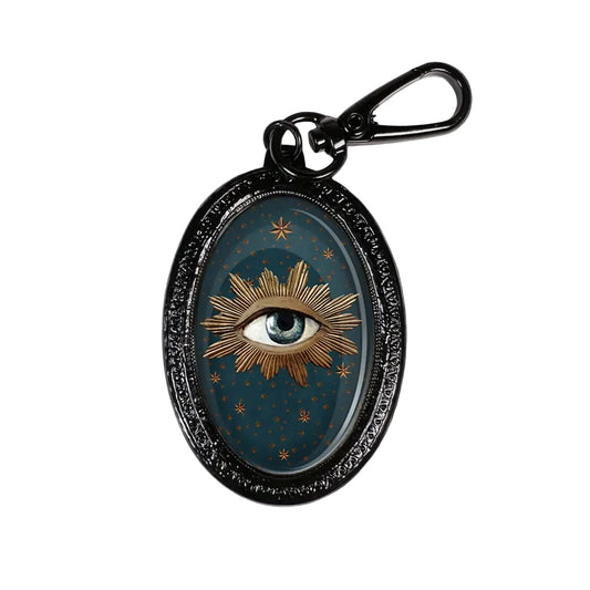 VOGLIO Bene Schlüsselanhänger Motiv Auge im Sternenhimmel, schwarzer Rahmen, mystisches Design.