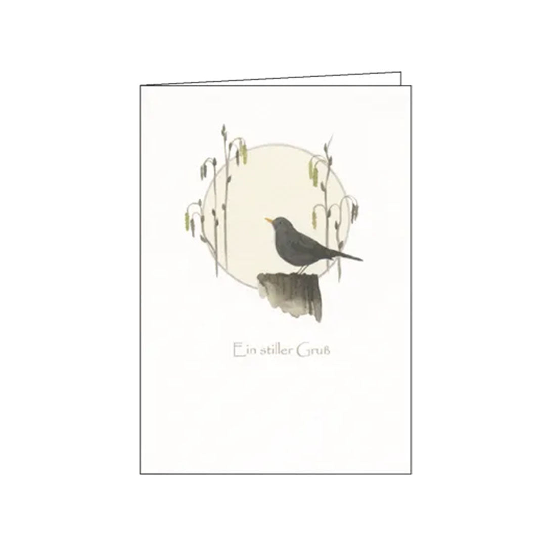 Schlichte Illustration einer schwarzen Amsel vor einer hellen Scheibe, umrahmt von feinen Gräsern. Ein dezenter Schriftzug wünscht einen stillen Gruß.